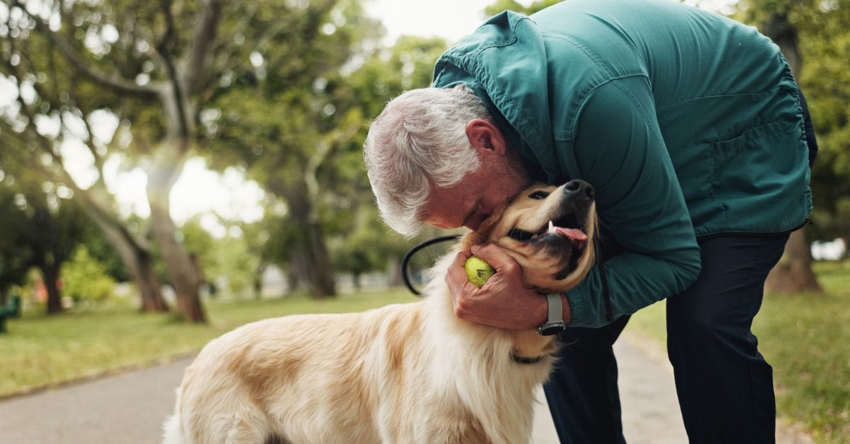 Senior gentleman loving on senior dog